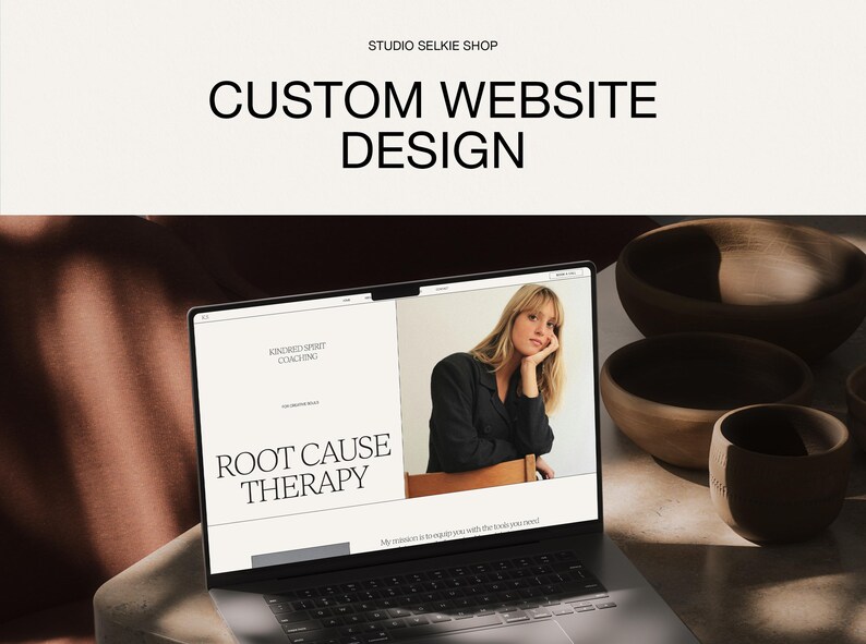 May include: A laptop screen displaying a website design with the text STUDIO SELKIE SHOP and CUSTOM WEBSITE DESIGN at the top. The webpage features the text KINDRED SPIRIT COACHING and ROOT CAUSE THERAPY alongside a photograph of a person.
