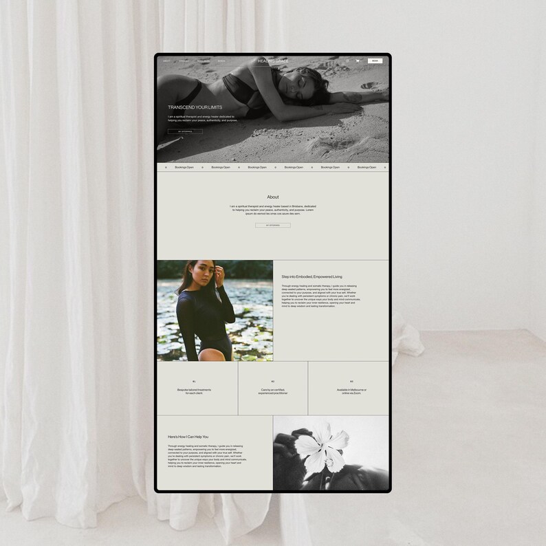 May include: A black and white website interface displayed on a screen, featuring a hero image of a person on a beach, text sections titled Transcend Your Limits, About, and Dive into Embodied Empowered Living, alongside a photograph of a flower.