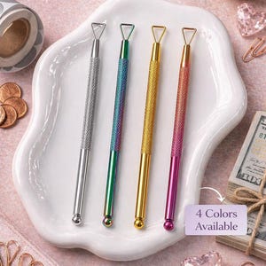 May include: Four scratch-off tools in silver, iridescent, gold, and pink, displayed on a white, wavy plate. Each tool has a textured handle and a triangular tip. The image includes text that says "Scratch-Off Tool" and "4 Colors Available."