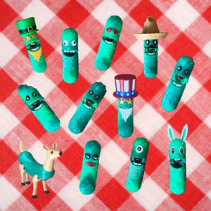 May include: A collection of whimsical green pickle figurines, each with a unique face and costume. Some wear hats, including a leprechaun hat, a sombrero, and a Uncle Sam hat. One is dressed as a deer with a teal outfit. Set against a red and white checkered background.