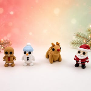 May include: Four small holiday-themed figurines arranged in a row. The set includes a brown gingerbread person, a white snowman with a light blue hat, a tan reindeer with a red nose, and a Santa Claus figure wearing a red suit and white beard.