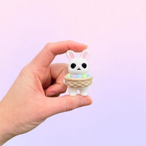 May include: A set of three ceramic mugs with a speckled, matte finish. The mugs are in shades of cream, light gray, and dark gray. Each mug has a simple, minimalist design, perfect for coffee or tea.