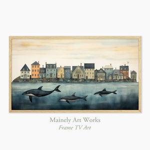 Könnte beinhalten: Ein Aquarellbild einer Reihe von bunten Häusern an einer Wasserfront mit drei schwarz-weißen Walen, die im Wasser darunter schwimmen. Der Text "Mainely Art Works Frame TV Art" befindet sich am unteren Rand des Bildes.