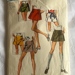 May include: Vintage Simplicity sewing pattern 8698 with illustrations of mini skirts. The pattern shows various skirt designs in different colors and patterns. The text indicates a size 6, waist 56 cm, and hip 82.5 cm. Skirt length is approximately 38 cm.