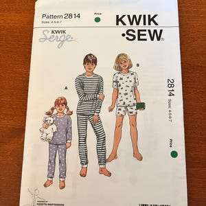 May include: A Kwik Sew pattern for children's sleepwear, pattern 2814, sizes 4-5-6-7. The cover features illustrations of children in pajamas. The pattern includes a variety of pajama styles. Designed by Kerstin Martensson.