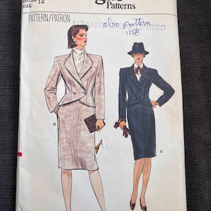 May include: Vogue Patterns sewing pattern, size 12. The pattern features illustrations of two women's suits. One suit is a light brown skirt suit, and the other is a navy blue skirt suit. The pattern number is 8845.