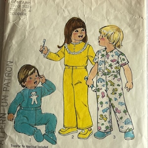 May include: Vintage Simplicity sewing pattern 7067 for toddler clothing. The pattern features illustrations of children in various outfits, including a blue jumpsuit, yellow jumpsuit, and patterned pajamas. The pattern includes sizes 3 and 4.