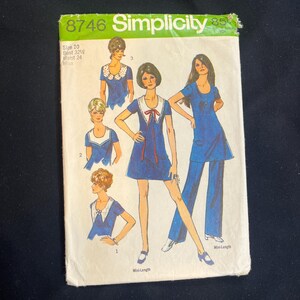 May include: Vintage Simplicity sewing pattern 8746. The pattern features illustrations of women's clothing designs, including dresses and a pantsuit. The pattern size is 10, with bust 82.5 cm and waist 61 cm. The pattern is for Misses.