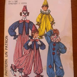 May include: Vintage Simplicity pattern #162 for boy and girl clown costumes. The illustration shows four different clown outfits in various colours, including blue, yellow, and red-and-white striped trousers. The pattern includes the text "ONE PATTERN UN PATRON".