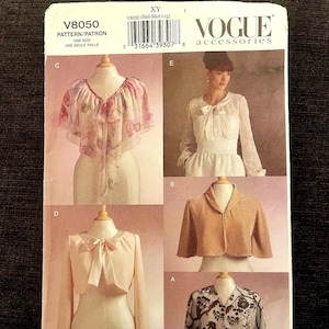 May include: Vogue Accessories pattern V8050 featuring various cape and bolero designs. The pattern includes images of the finished garments, showcasing different styles and fabrics. The pattern is labeled "One Size" and includes the text "PATTERN/PATRON".