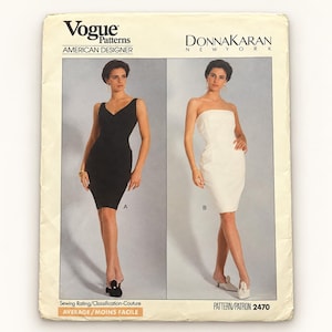 May include: A Vogue Patterns sewing pattern envelope for Donna Karan New York, number 2470. The front displays two dress variations: a black sleeveless V-neck dress labeled A and a white strapless dress labeled B. The sewing rating is Average.