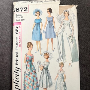 May include: A vintage Simplicity sewing pattern, number 5872, with dress designs, including a bridal gown. The pattern is for a Junior size 11 with a 80 cm bust. The cover displays the text "Simplicity Fashion Magazine".