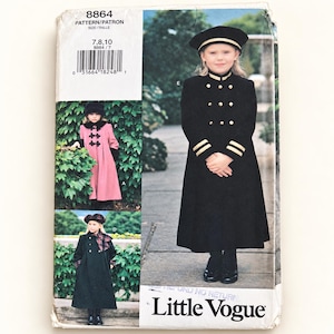 May include: A Little Vogue sewing pattern envelope 8864 for sizes 7, 8, 10. The cover displays three variations of a long coat and matching hat. One version is black with gold buttons and trim, another is pink with black toggles, and one is black.