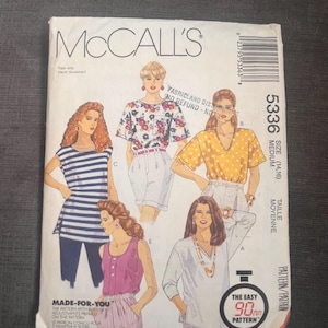 May include: A vintage McCall's sewing pattern envelope with illustrations of tops. The envelope shows the number 5336, size medium, and the text "Made-For-You". The design includes a striped top and a floral print top. The pattern is described as an easy 90-minute pattern.