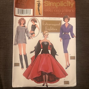 May include: A vintage Simplicity Doll Collector's Club pattern for 11.5-inch dolls. The cover features illustrations of dolls in 1980s fashions, including a red ball gown and a purple suit. The pattern is labeled "Extravagant Eighties."