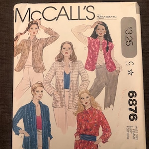 May include: Vintage McCall's sewing pattern featuring illustrations of women's blouses. The pattern cover displays various blouse designs in shades of blue, red, and beige. The pattern number is 6876.