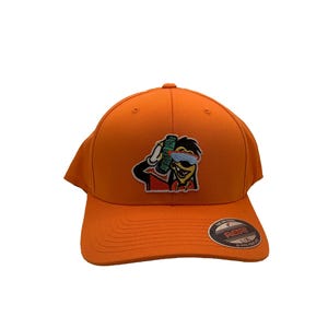 May include: Orange baseball cap featuring a cartoon character wearing sunglasses and holding money. The character is wearing a red vest and a gold chain. The cap has a black and white "The Original" logo with the text "REDEF" and "U.F.A."