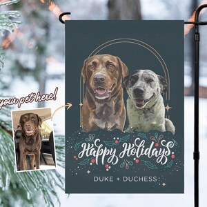 May include: A personalized garden flag featuring two dogs with a holiday theme. The flag has a dark teal background with the words "Happy Holidays" in script, along with the names "DUKE + DUCHESS". An inset photo shows a brown dog.