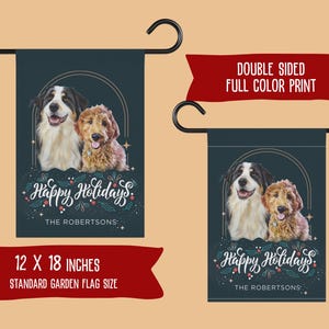 May include: Double-sided garden flag featuring two dogs with the text "Happy Holidays" and "The Robertsons." The flag is 12 x 18 inches and has a full-color print. The design includes a black, white, and brown dog and a golden dog.
