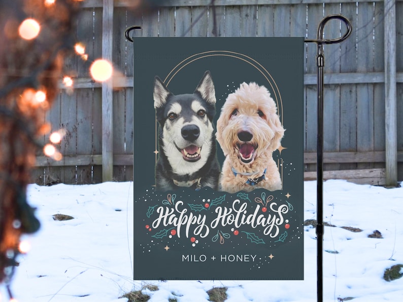 May include: A decorative garden flag featuring two dogs, a Husky and a Goldendoodle, with the words "Happy Holidays" in white script. The flag is dark teal with a gold circular design and the names "Milo + Honey" at the bottom.