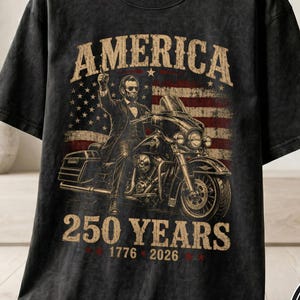 Black t-shirt with Abraham Lincoln on a motorcycle, "America 250 Years 1776 2026".
