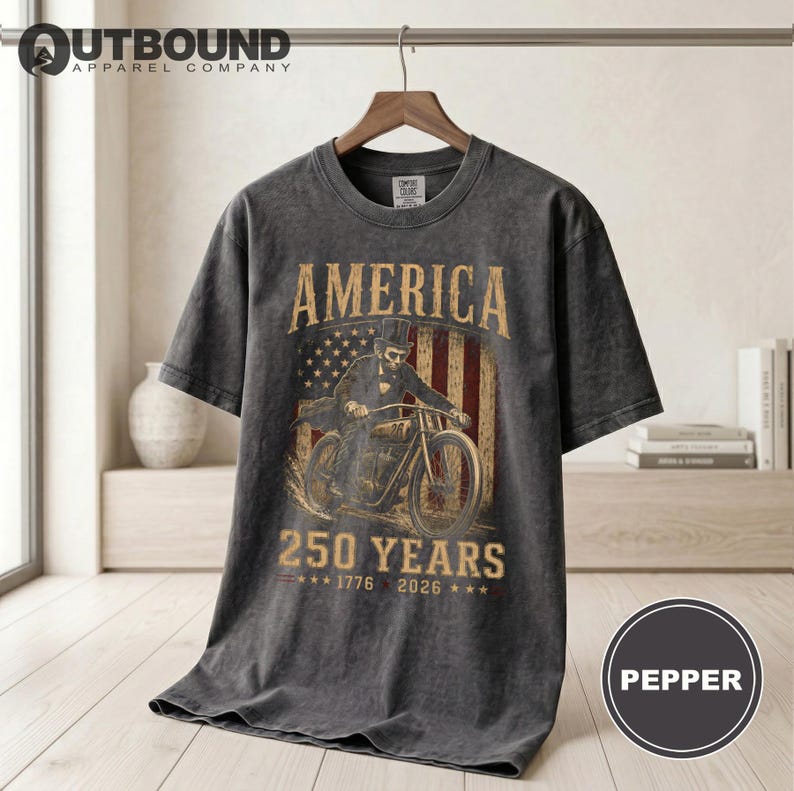 Dark t-shirt with "AMERICA 250 YEARS 1776 2026" and motorcycle graphic.