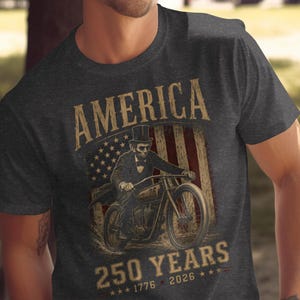 Man in patriotic t-shirt featuring Abraham Lincoln on a motorcycle, American flag, and text.