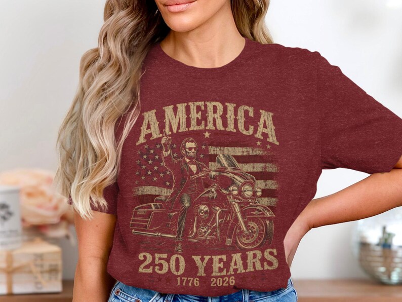 Maroon t-shirt with graphic of man on motorcycle, American flag, and "America 250 Years" text.