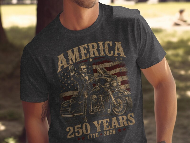 Abraham Lincoln on motorcycle with "America 250 Years" text and US flag.