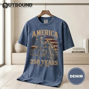 Denim t-shirt with American flag, motorcycle, and "America 250 Years" text.