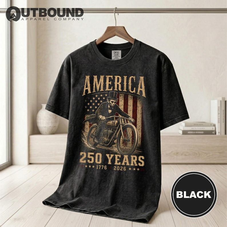 Black t-shirt with "America 250 Years 1776 2026" and patriotic imagery.