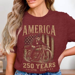 Abraham Lincoln on motorcycle with American flag and "America 250 Years 1776-2026".