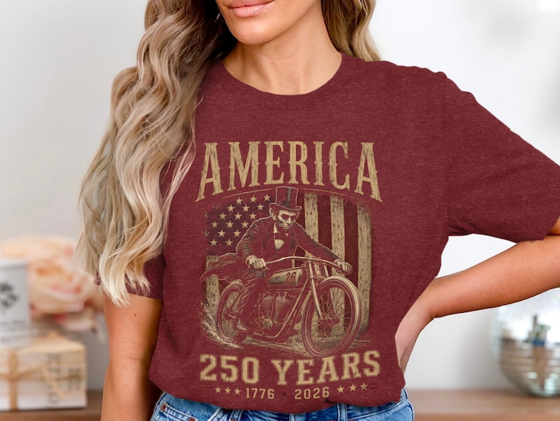 Abraham Lincoln on motorcycle with American flag and "America 250 Years 1776-2026".