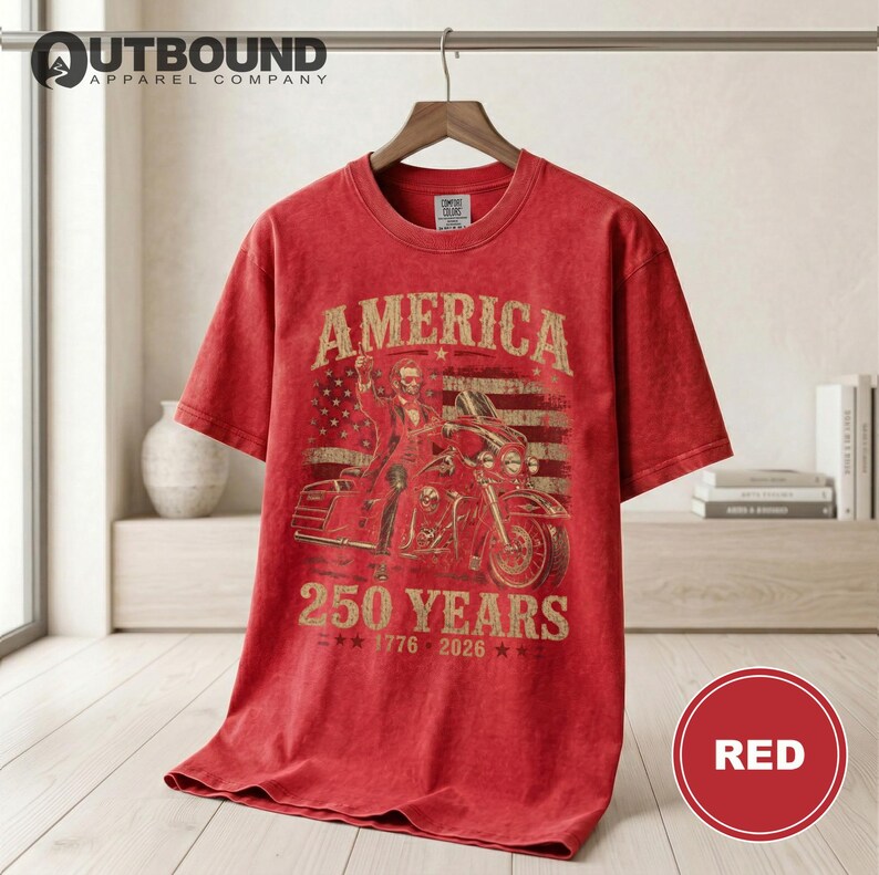 Red t-shirt with "America 250 Years 1776-2026" text and motorcycle graphic.