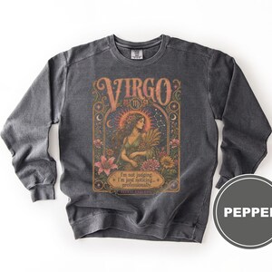 Dark gray sweatshirt with a "VIRGO" zodiac graphic featuring a woman surrounded by celestial elements.