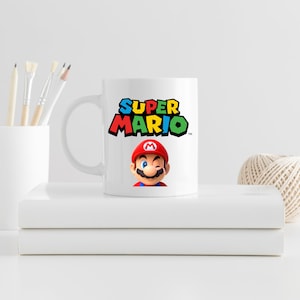 May include: White ceramic mug with a colorful "Super Mario" logo and a cartoon image of Mario with a red hat and mustache.
