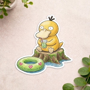 May include: A die-cut sticker featuring a yellow duck-like creature with a wide beak sitting on a brown tree stump. The creature holds a glass with a red straw and ice cubes. A green inflatable pool ring with pink heart patterns sits nearby.