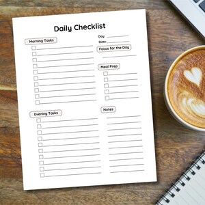 May include: A printable daily checklist with sections for morning tasks, focus for the day, meal prep, evening tasks, and notes. The checklist has blank lines for writing tasks and a checkbox next to each line.