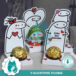 Może przedstawiać: Drukowany szablon kartki walentynkowej z kreskówkową parą trzymającą serce i tabliczkę z napisem "Feliz San Valentin". Szablon jest przeznaczony do użycia z czekoladowym jajkiem i małym pudełkiem.