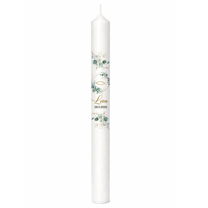 May include: A white pillar candle decorated with a gold fish symbol, green eucalyptus leaves, and the name "Leon" in gold script. The date "28.11.2026" is also printed on the candle. The candle has a simple, elegant design.