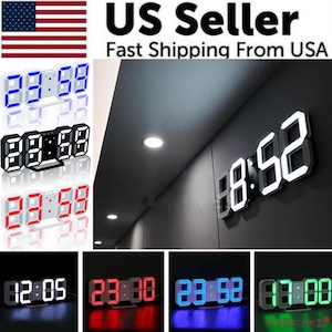 May include: A white digital clock with large, black numbers displays the time 18:52. The clock is mounted on a wall and is illuminated by a white light. The clock is shown in different colors, including blue, red, and green.