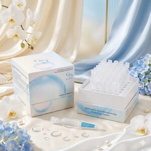 May include: A skincare product display featuring two white boxes and a single ampoule. The boxes are labeled with text and a blue graphic. One box is open, revealing multiple small, clear ampoules. The text "Hyaluronic Acid Moisturizing Hydrating Serum" is visible.