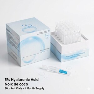 May include: A skincare product set featuring a box and a tray of small vials. The box is white with blue accents and text, including "5% Hyaluronic Acid" and "Noix de coco." The tray holds multiple clear vials, with one vial lying in front. The text on the box reads "Hyaluronic Acid Moisturising Hydrating Serum."