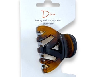 May include: A brown and black plastic hair claw clip on a white card with the text "Diva Luxury Hair Accessories Static-Free".