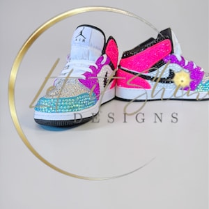 May include: A set of three ceramic mugs with a speckled, matte finish. The mugs are in shades of cream, light gray, and dark gray. Each mug has a simple, minimalist design, perfect for coffee or tea.