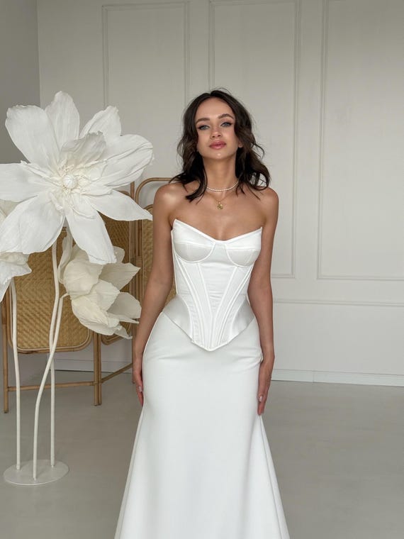 bridal corset for under dress The Pearl Blossom Mikado Top This wedding gown features a fitted bodice with lace detailing and a flowing skirt This Season's Corset Wedding Dress