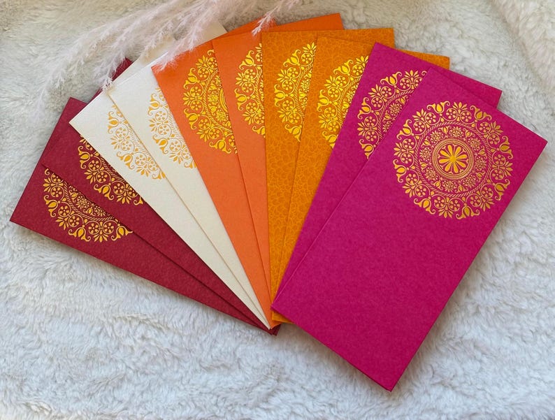 May include: A set of colorful envelopes with gold mandala designs. The envelopes are arranged in a fan shape, with the red envelope at the bottom and the orange envelope at the top.