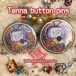 May include: Two round button pins with a TV design, featuring the text "ITS TV TIME". The pins are surrounded by a gold border and colorful accents. The image also includes a pink star-shaped hair clip and beaded jewelry.