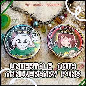 May include: Two round Undertale 10th Anniversary pins. One pin features a white character with the text "I Voted Togore". The other pin features a character with brown hair and the text "I Voted Chara". Both pins are green, red, and white.