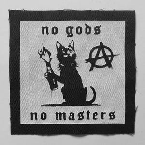 May include: A square black and white fabric patch featuring a black cat holding a flaming bottle. The text no gods is printed above the cat and no masters is printed below. An anarchy symbol is positioned to the right of the cat's head.